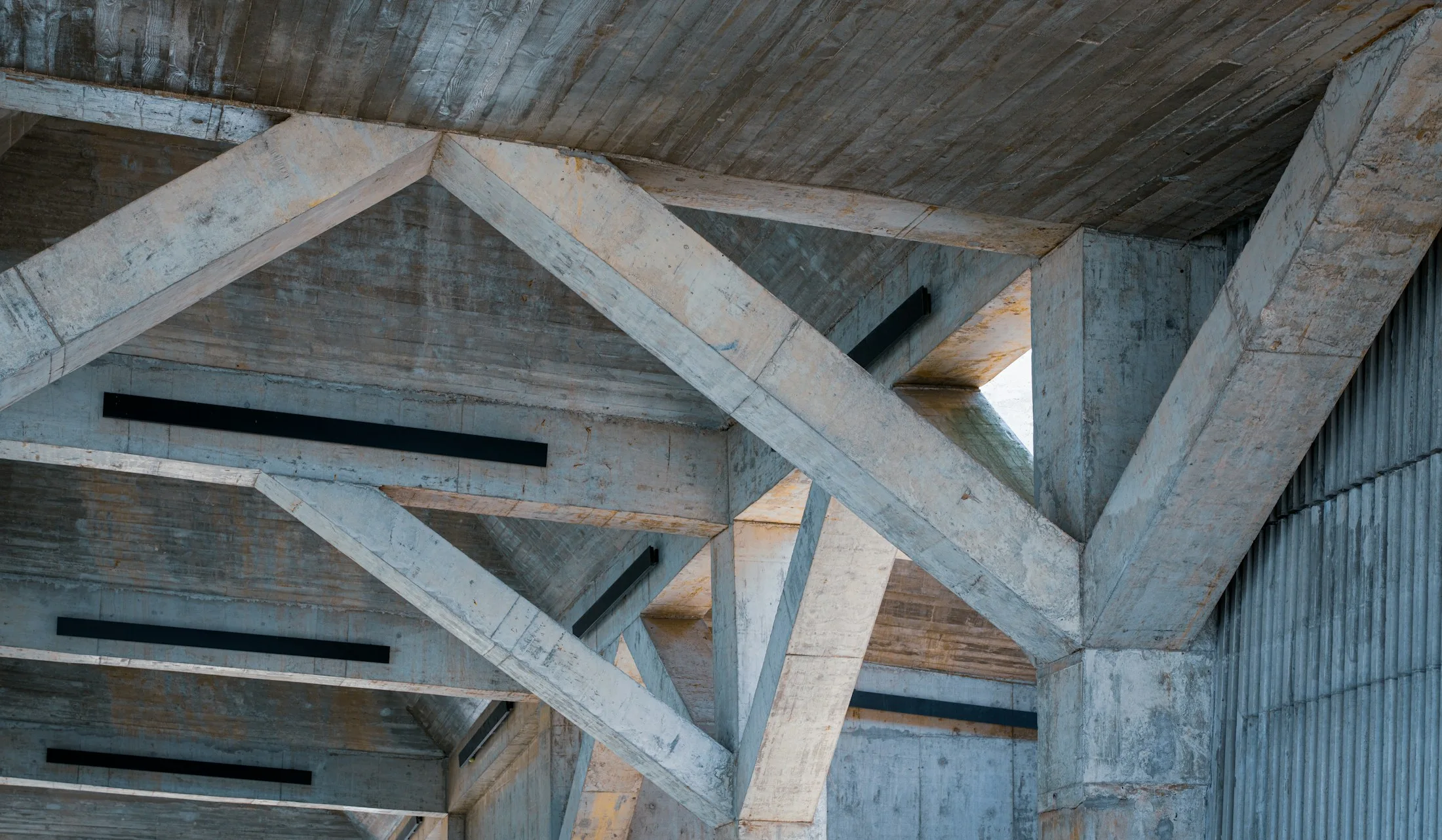Intersecting exposed concrete beams and structural connections